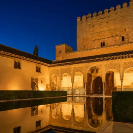 Alhambra Nasrid Palaces illuminated at night in Granada Spain — Alhambra night tour attendance revenue