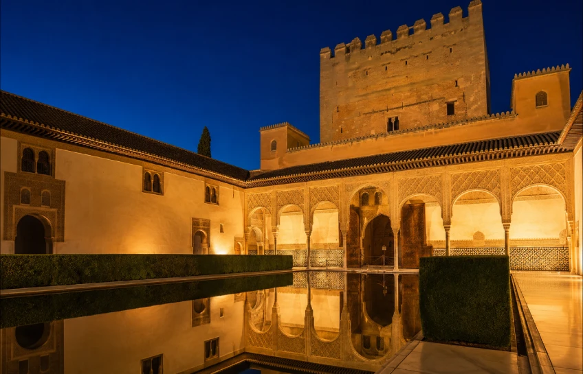Alhambra Nasrid Palaces illuminated at night in Granada Spain — Alhambra night tour attendance revenue