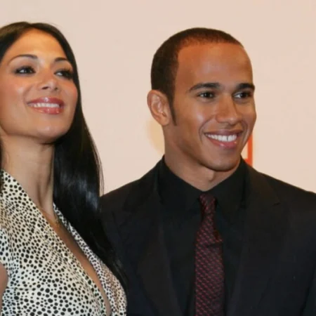 Nicola Lockhart and Lewis Hamilton smiling together at a public event