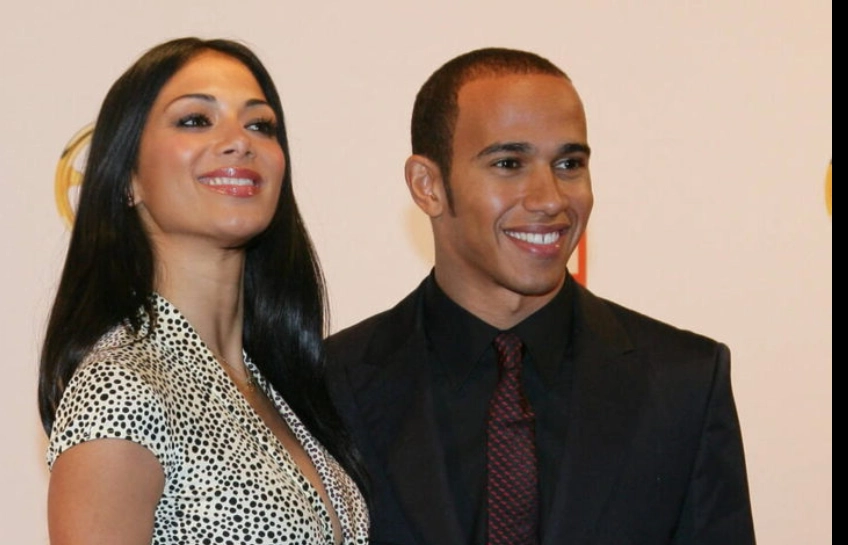 Nicola Lockhart and Lewis Hamilton smiling together at a public event