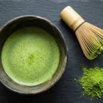 A bowl of freshly whisked matcha showing what does matcha taste like — smooth, grassy, and bright green