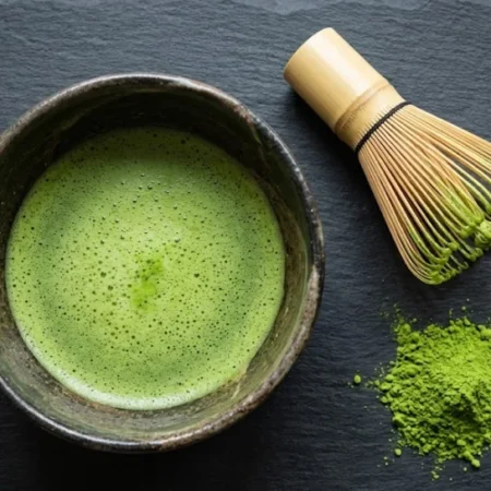 A bowl of freshly whisked matcha showing what does matcha taste like — smooth, grassy, and bright green