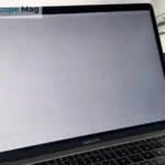 MacBook Pro screen showing faint burn marks and ghost image retention on a gray background
