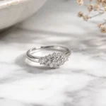 Timeless Designs Sterling 1.00 sterling silver cluster ring with accent stones on marble surface
