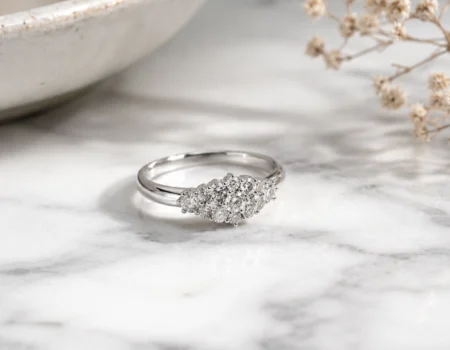 Timeless Designs Sterling 1.00 sterling silver cluster ring with accent stones on marble surface