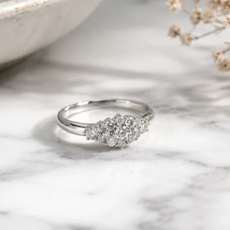 Timeless Designs Sterling 1.00 sterling silver cluster ring with accent stones on marble surface