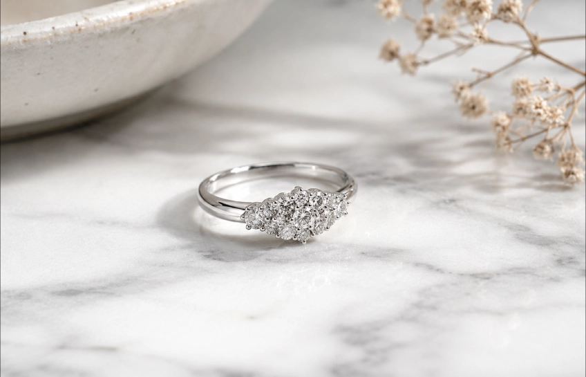 Timeless Designs Sterling 1.00 sterling silver cluster ring with accent stones on marble surface