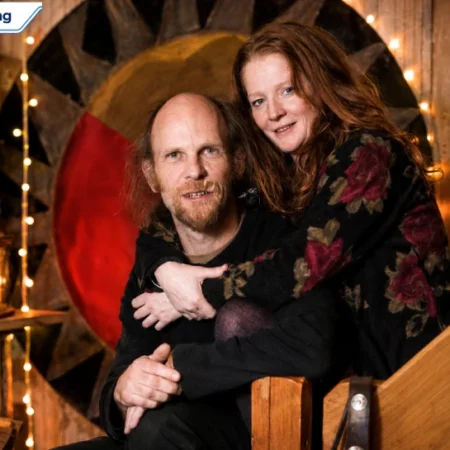 Geoff Dwight pictured with a woman in a rustic indoor setting in North Wales